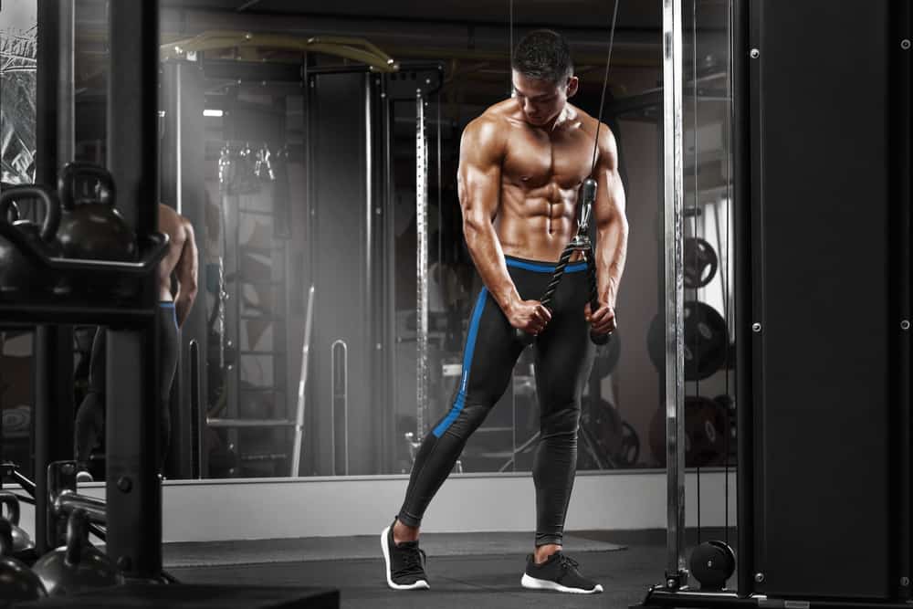 Strong man working on triceps in gym Singapore